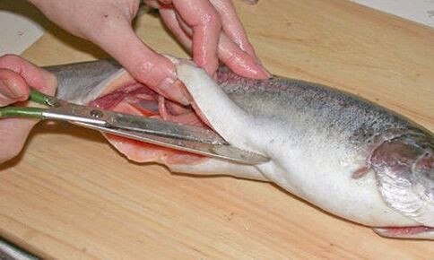 Das sorgfältige Schneiden von Fisch auf einem persönlichen Schneidebrett schützt vor einer Parasiteninfektion.